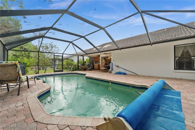 view of pool with a patio area and a lanai