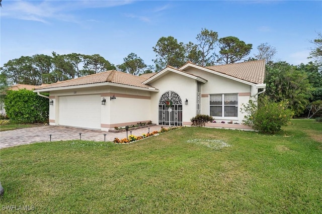 view of front of property with a garage and a front lawn