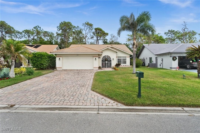 view of front of property featuring a garage and a front lawn