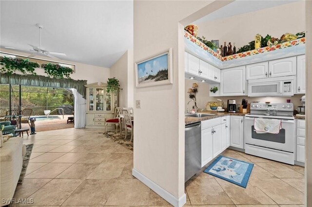 kitchen featuring ceiling fan, sink, light tile patterned floors, white appliances, and white cabinets