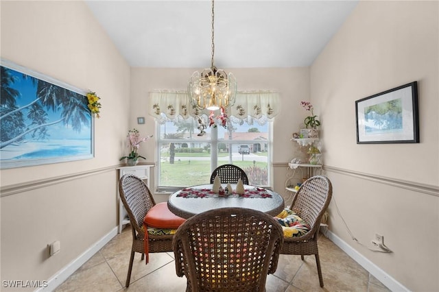 dining room featuring light tile patterned flooring and an inviting chandelier