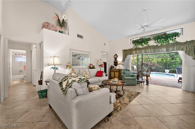 living room featuring ceiling fan, high vaulted ceiling, and light tile patterned flooring