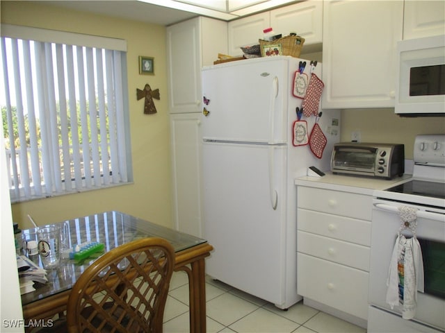 kitchen featuring white cabinets, white appliances, and light tile patterned floors