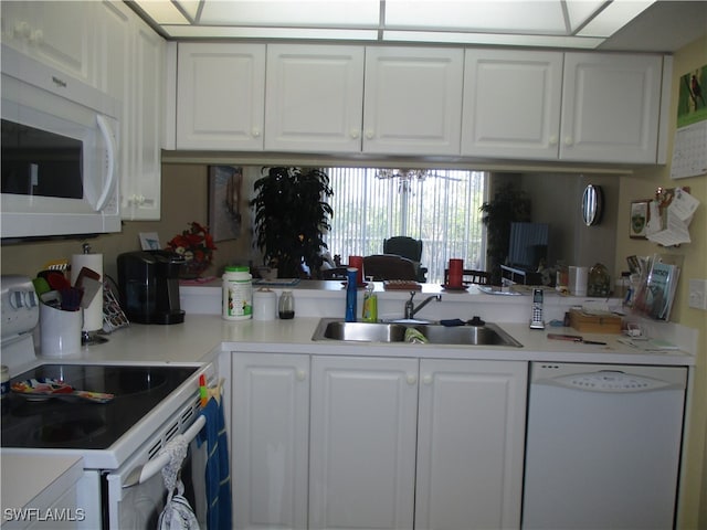 kitchen featuring white cabinetry, white appliances, and sink