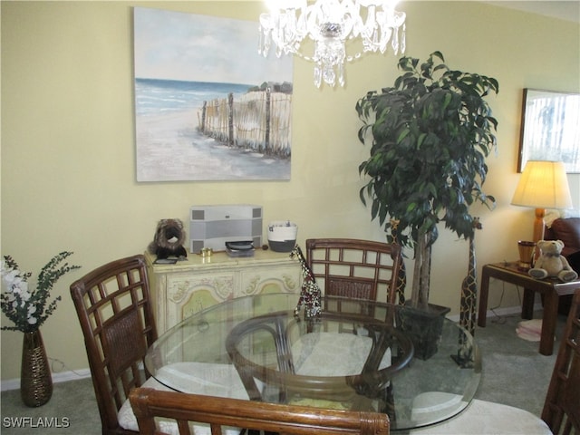 dining area featuring carpet and an inviting chandelier