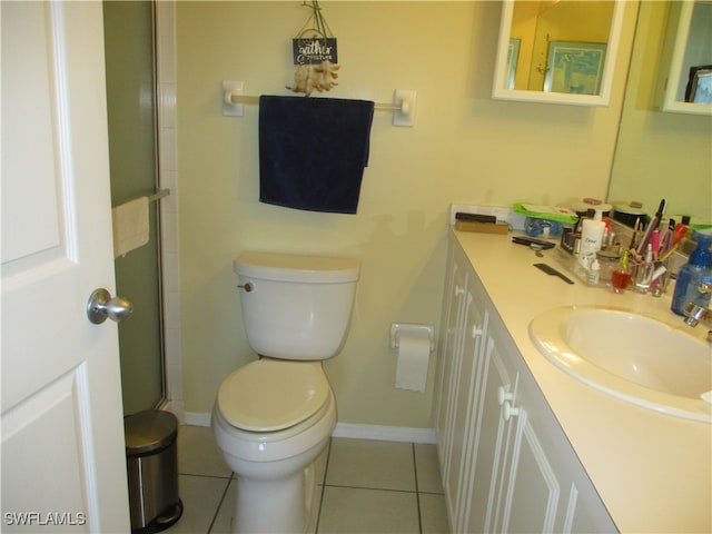 bathroom featuring tile patterned floors, vanity, toilet, and a shower with shower door