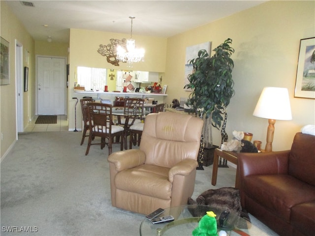 living room with a notable chandelier and light colored carpet