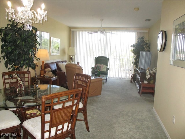 dining space with plenty of natural light, carpet floors, and a chandelier