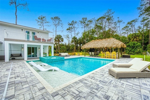 view of pool featuring an outdoor living space, a pool with connected hot tub, french doors, a patio area, and outdoor dry bar
