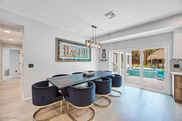 dining room featuring a chandelier and light hardwood / wood-style floors