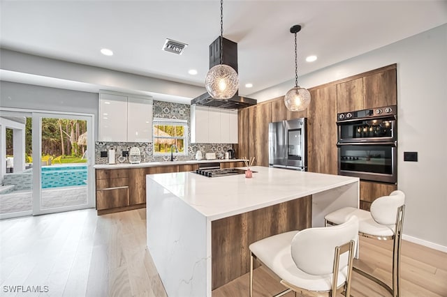 675 Logan Blvd S, Naples, FL 34119 - kitchen with appliances with stainless steel finishes, modern cabinets, white cabinets, decorative light fixtures, and recessed lighting