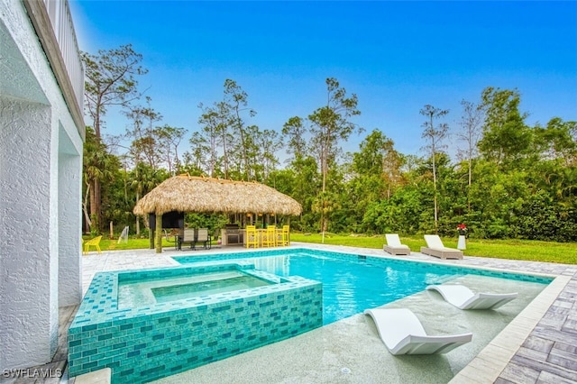 view of swimming pool featuring a gazebo and an in ground hot tub