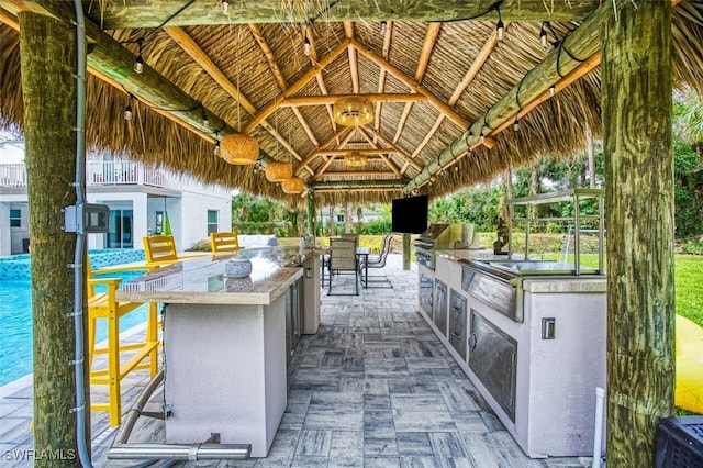 view of patio / terrace with area for grilling, a gazebo, and an outdoor bar