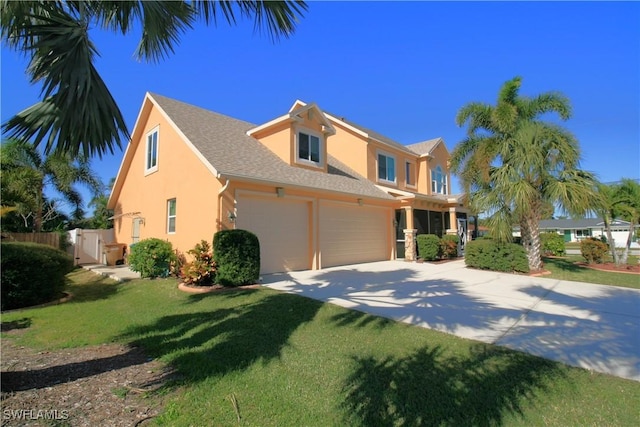 view of front of house with a front yard and a garage