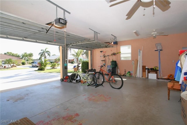 garage with a garage door opener and ceiling fan