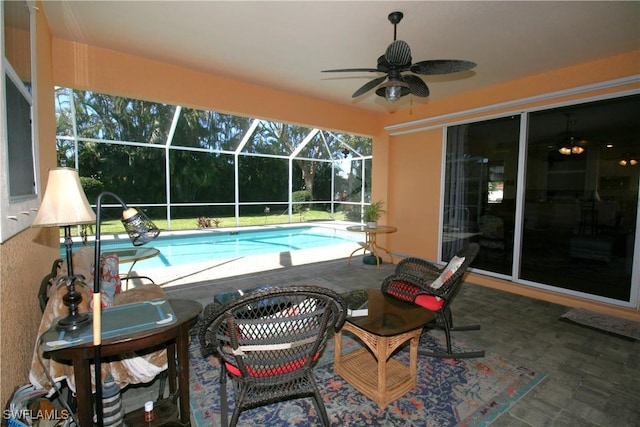 view of swimming pool with a patio, ceiling fan, and a lanai