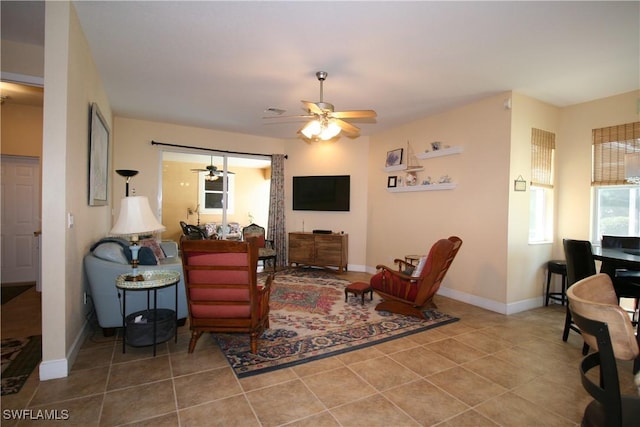 tiled living room featuring ceiling fan