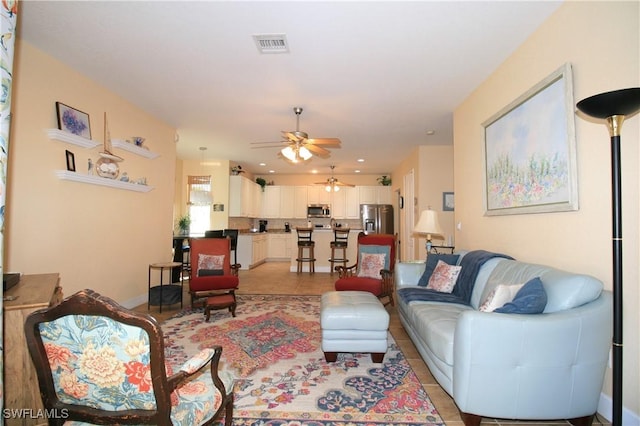 tiled living room with ceiling fan