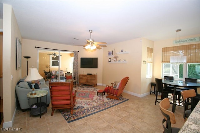 tiled living room with ceiling fan