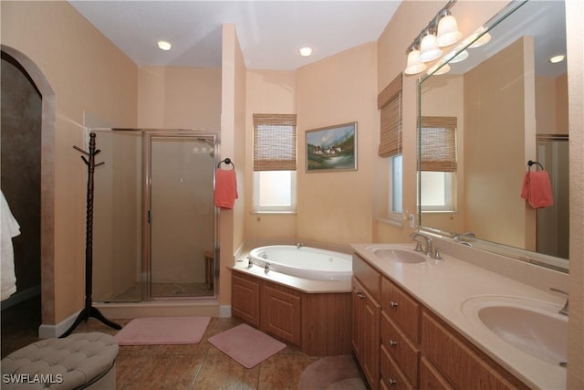 bathroom with vanity, tile patterned flooring, and plus walk in shower