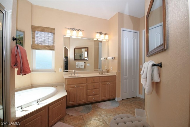 bathroom with tile patterned flooring, vanity, and a bathing tub