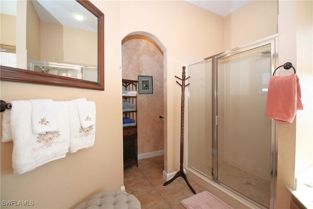 bathroom with tile patterned floors and a shower with door