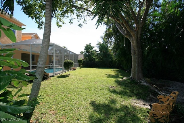 view of yard with glass enclosure