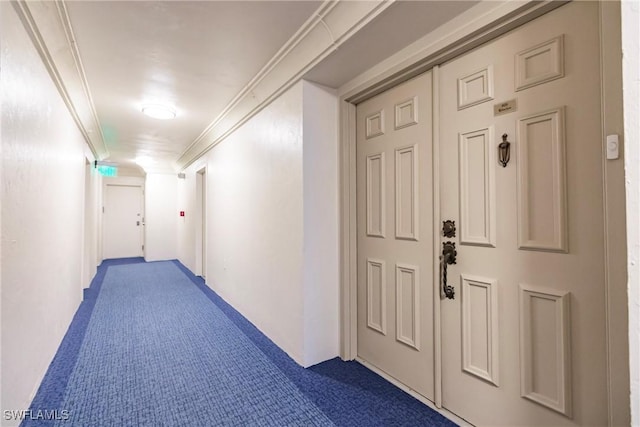 hallway featuring carpet flooring and ornamental molding