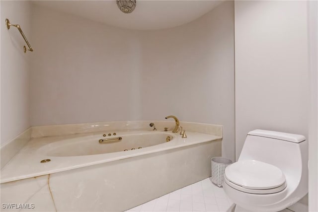 bathroom with tile patterned flooring, a bath, and toilet