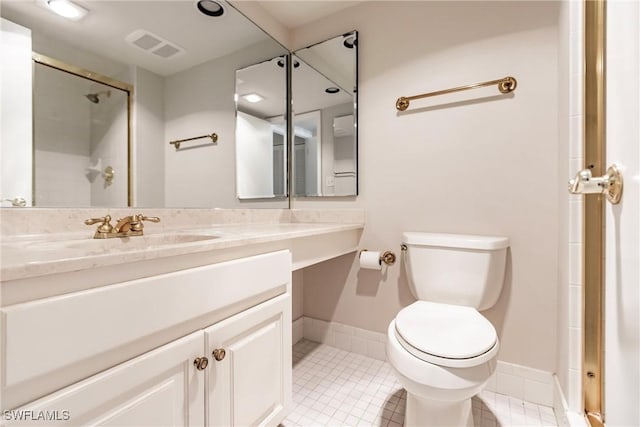 bathroom with tile patterned flooring, vanity, toilet, and an enclosed shower