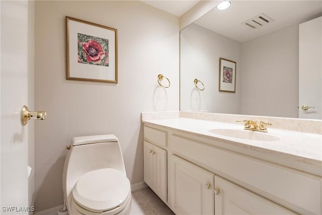 bathroom with tile patterned floors, vanity, and toilet