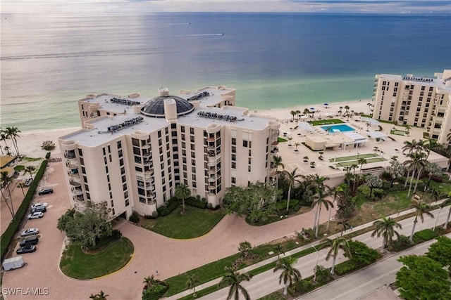 drone / aerial view with a water view and a beach view