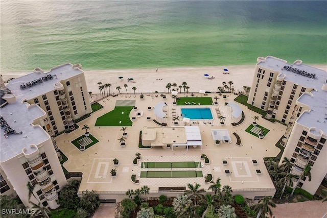 birds eye view of property featuring a view of the beach and a water view