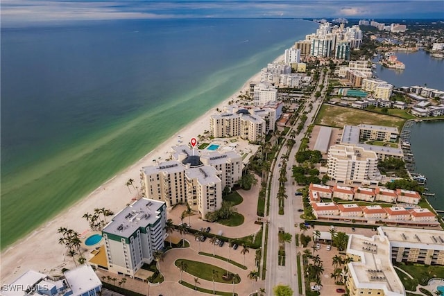 drone / aerial view with a water view and a beach view