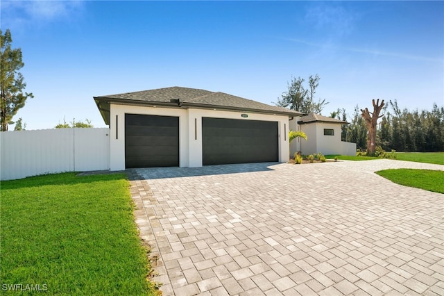 view of front of home featuring a garage and a front lawn