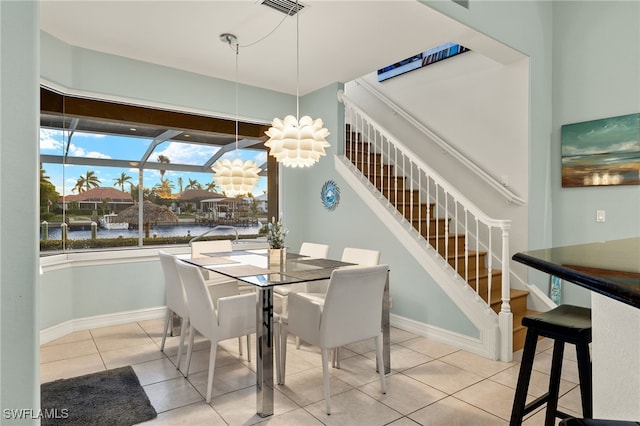 dining space featuring tile patterned flooring, visible vents, stairway, and baseboards