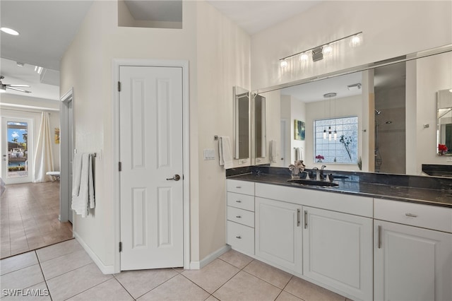 bathroom with tile patterned floors, ceiling fan, a shower, and vanity