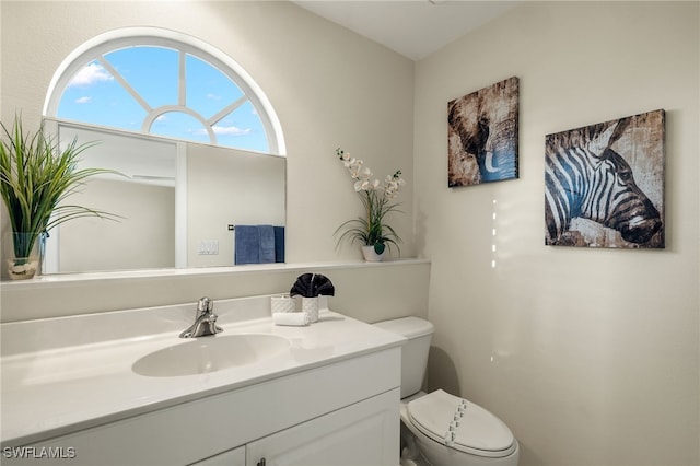 bathroom featuring vanity and toilet