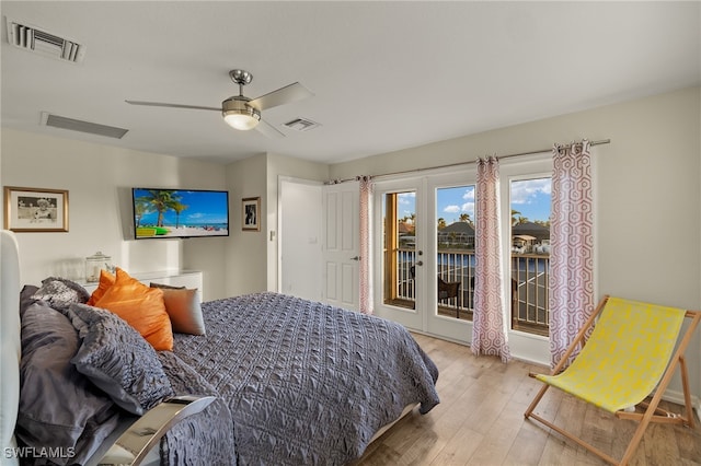bedroom featuring access to exterior, visible vents, and hardwood / wood-style floors