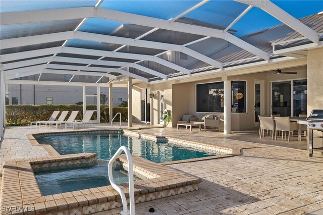 view of swimming pool with glass enclosure, ceiling fan, a patio, and a grill