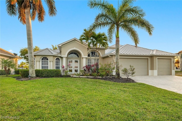 view of front of home featuring a front yard and a garage