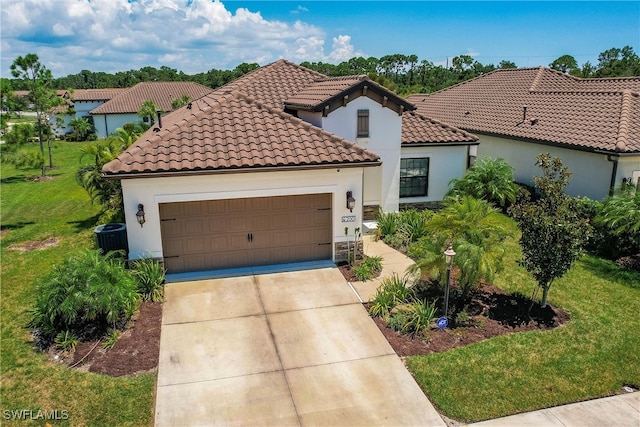 mediterranean / spanish home with central AC, a garage, and a front lawn