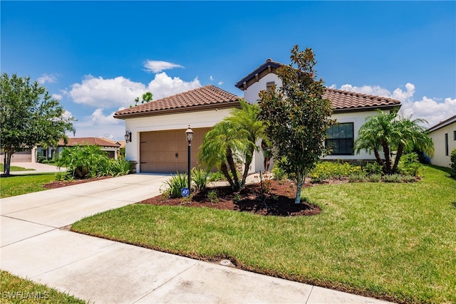 mediterranean / spanish home featuring a front yard and a garage