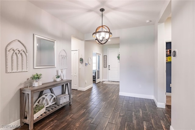 foyer entrance featuring a notable chandelier and dark hardwood / wood-style floors