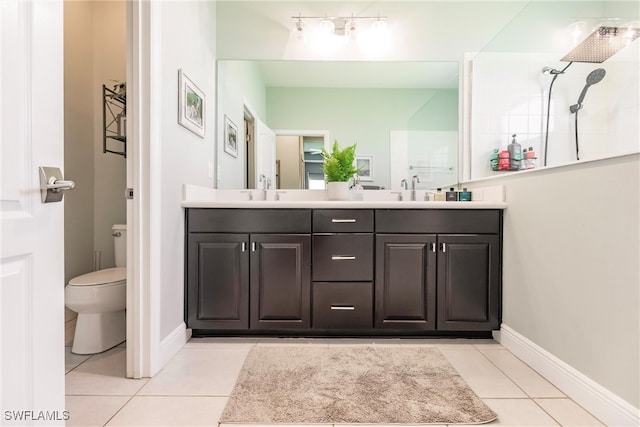 bathroom with tile patterned flooring, a shower, vanity, and toilet