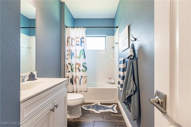 full bathroom with hardwood / wood-style floors, vanity, shower / tub combo, and toilet