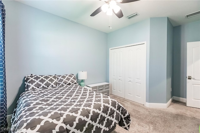 carpeted bedroom with ceiling fan and a closet