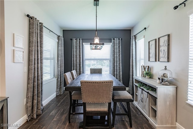 dining space with a healthy amount of sunlight and dark hardwood / wood-style flooring