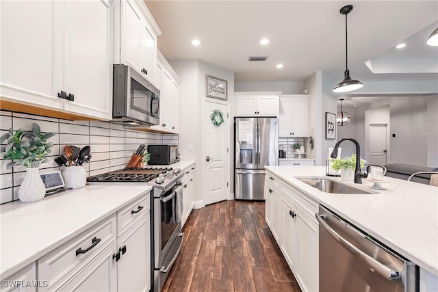 kitchen featuring white cabinets, dark hardwood / wood-style flooring, stainless steel appliances, and sink