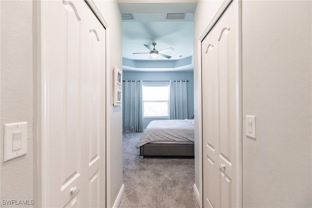 hallway featuring light colored carpet